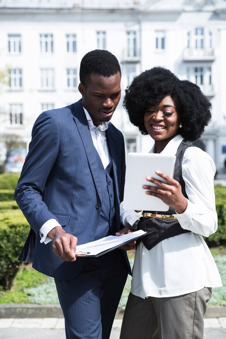 portrait-african-young-businessman-businesswoman-looking-digital-tablet_23-2148190688
